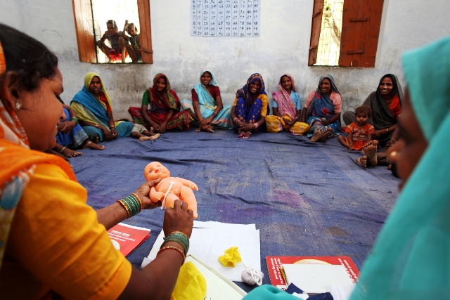 Expecting mothers and their mother-in-laws learn about how to safely sever the umbilical cord of a newborn at a Sure Start facilitated Mothers’ Group Meeting in Sabji Village, Rae Bareilly District, Uttar Pradesh, India