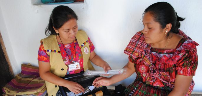 A family planning user and a health promoter discuss contraceptive methods in El Quiché, Guatemala.